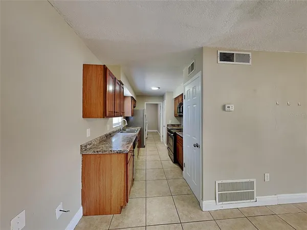 a kitchen with stainless steel appliances granite countertop a refrigerator and a stove