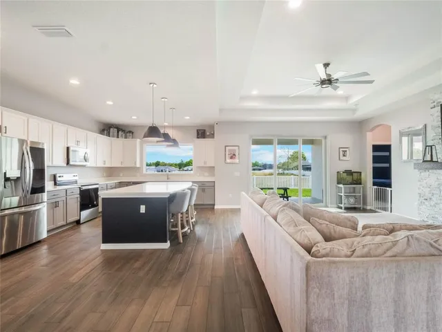 a kitchen with a sink a counter top space stainless steel appliances and a window