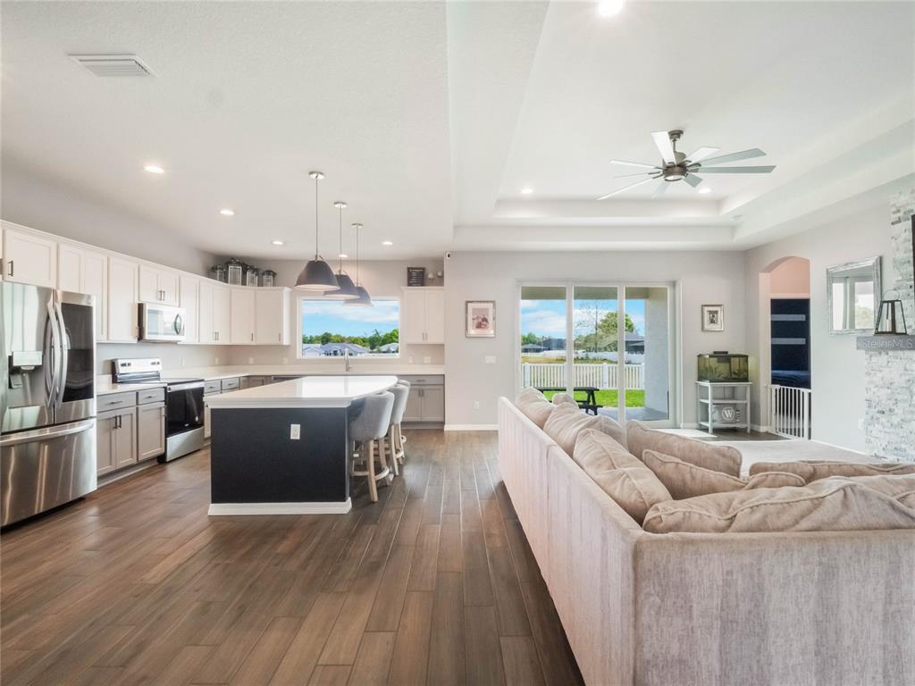4735 Northwest 11th Court Ocala, FL 34475 - Photo 14 of 34 a large kitchen with stainless steel appliances lots of counter space dining table and a large window