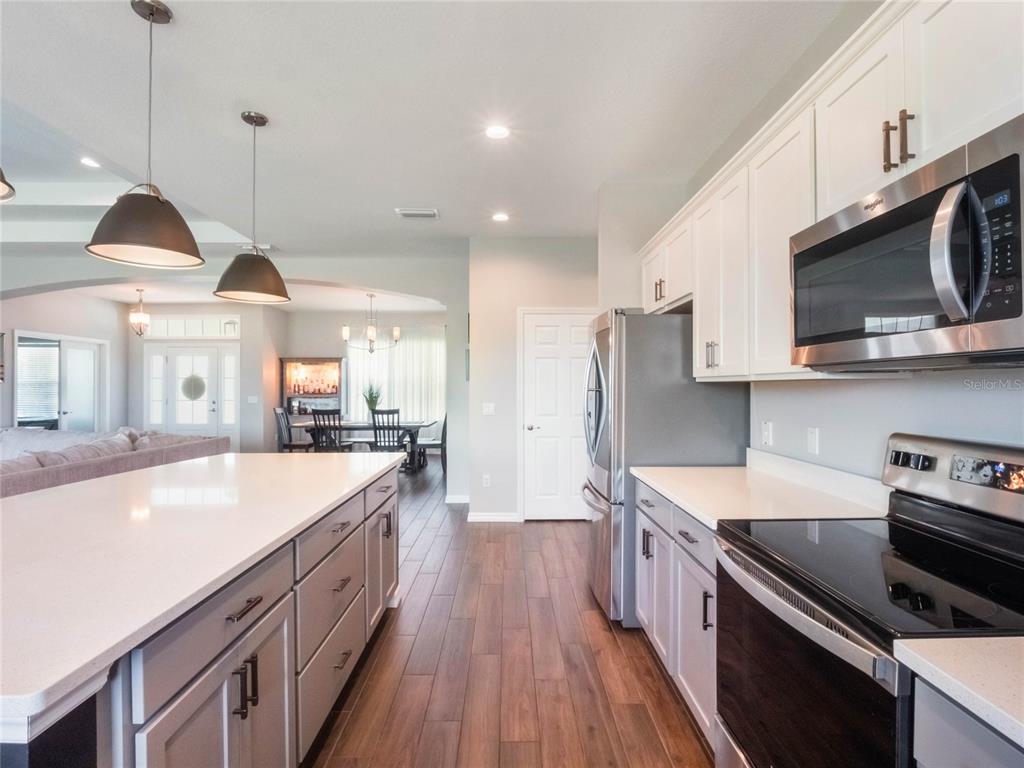 4735 Northwest 11th Court Ocala, FL 34475 - Photo 17 of 34 a kitchen with stainless steel appliances granite countertop a sink a stove and a wooden floors