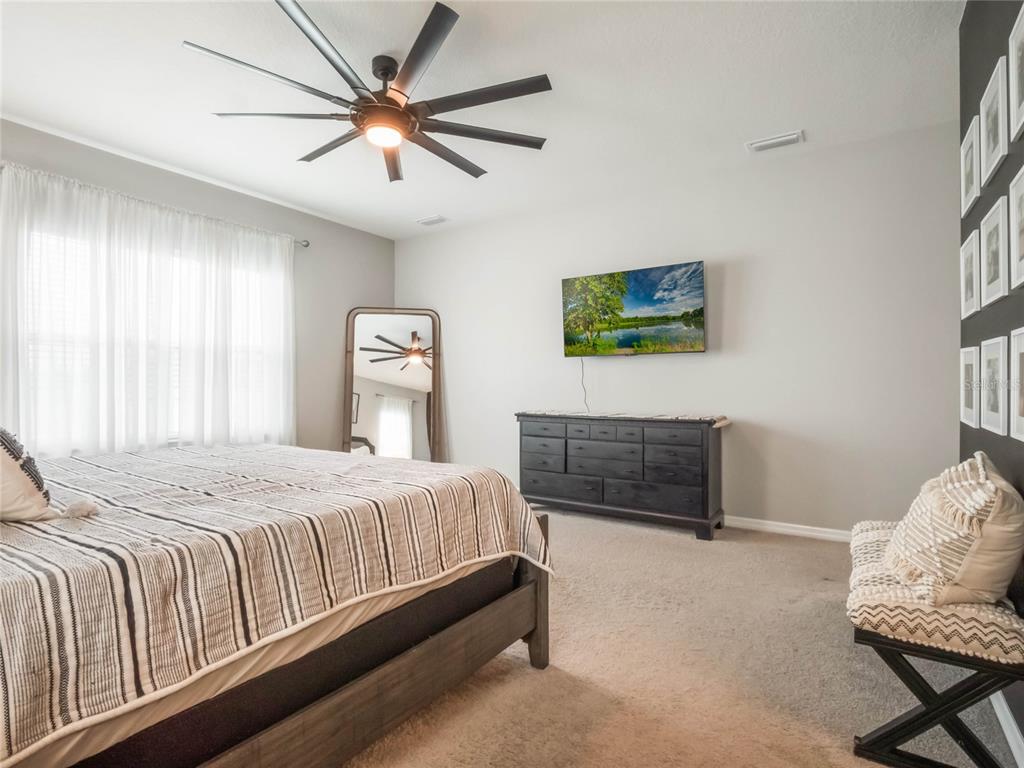 4735 Northwest 11th Court Ocala, FL 34475 - Photo 19 of 34 a bedroom with a bed and a television