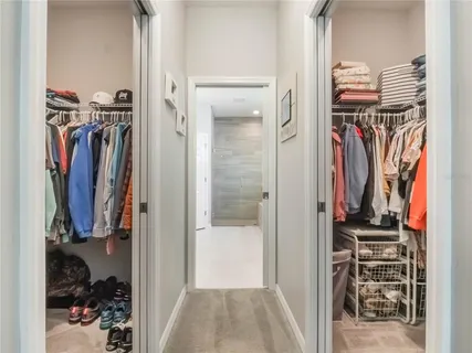 a bathroom with a double vanity sink a toilet and shower