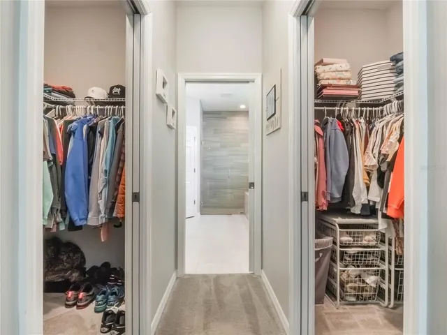 a bathroom with a double vanity sink a toilet and shower