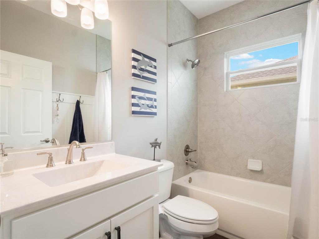 4735 Northwest 11th Court Ocala, FL 34475 - Photo 27 of 34 a bathroom with a sink a toilet and shower