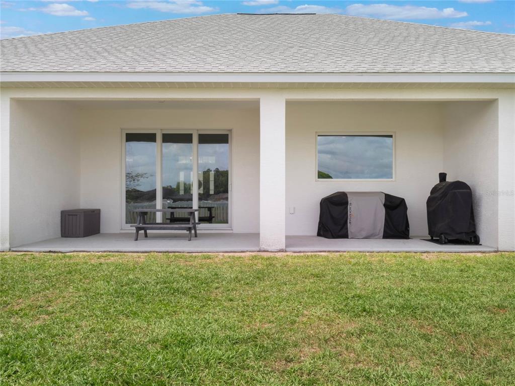 4735 Northwest 11th Court Ocala, FL 34475 - Photo 30 of 34 a view of a bedroom with a large window and a large tree