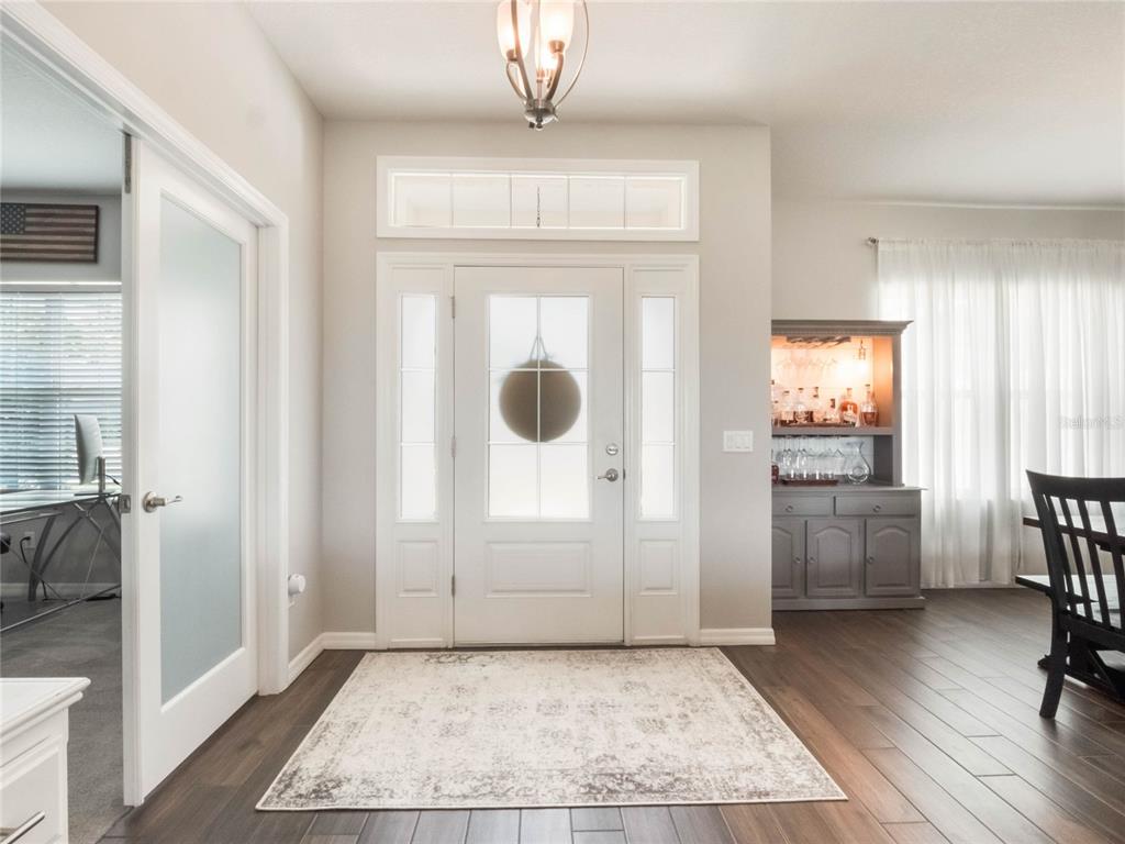 4735 Northwest 11th Court Ocala, FL 34475 - Photo 3 of 34 a view of a hallway to a livingroom with furniture and windows