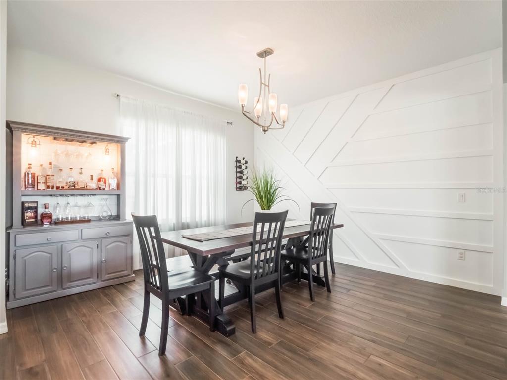 4735 Northwest 11th Court Ocala, FL 34475 - Photo 4 of 34 a view of a dining room with furniture window and wooden floor