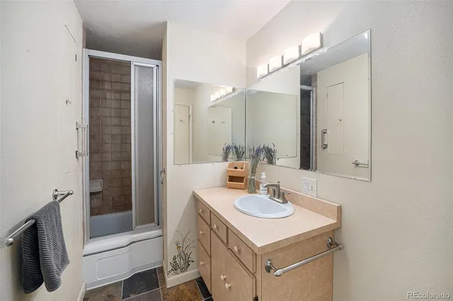 a bathroom with a sink a mirror and a shower