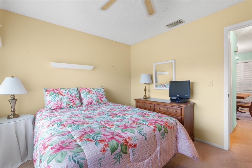 4445 Pelorus Drive New Port Richey, FL 34652 - Photo 17 of 26 a bedroom with a bed and a flat screen tv