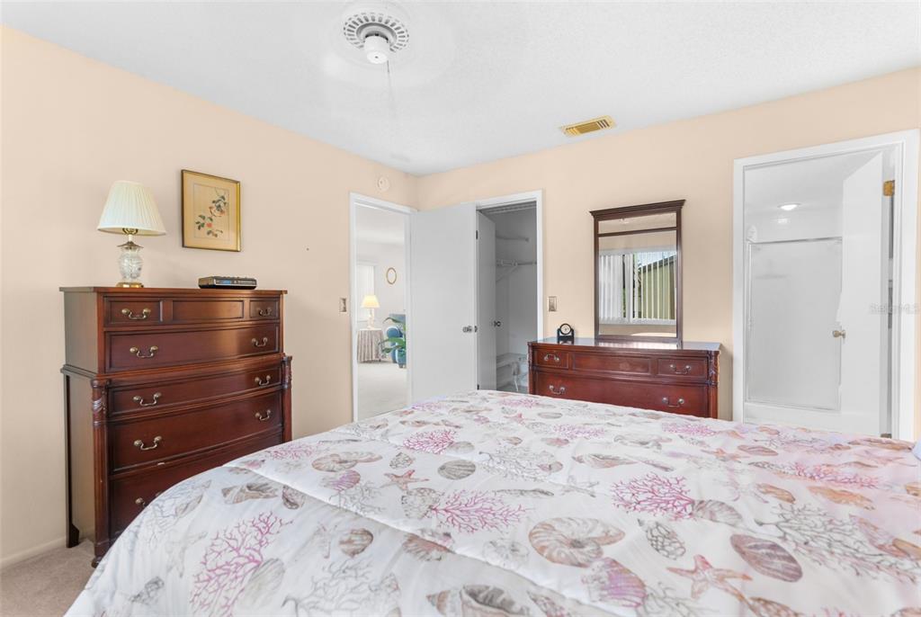 4445 Pelorus Drive New Port Richey, FL 34652 - Photo 21 of 26 a bedroom with a bed and a dresser