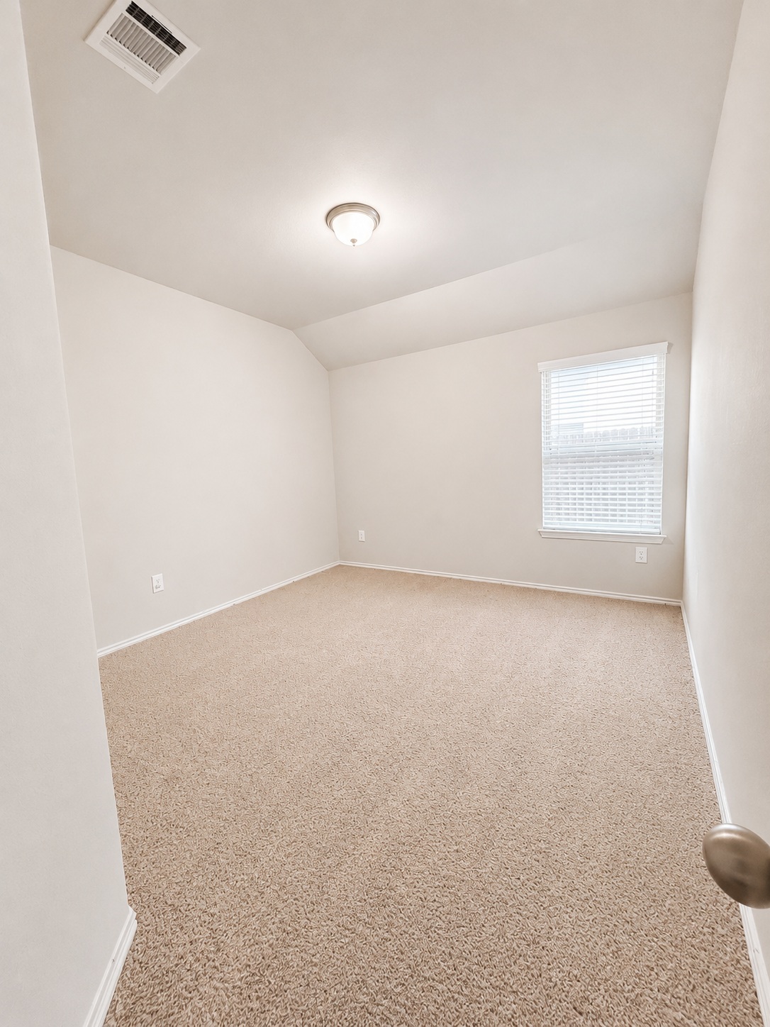 187 Limerick Road Buda, TX 78610 - Photo 12 of 18 A well-lit bedroom features plush carpeting and ample natural light.