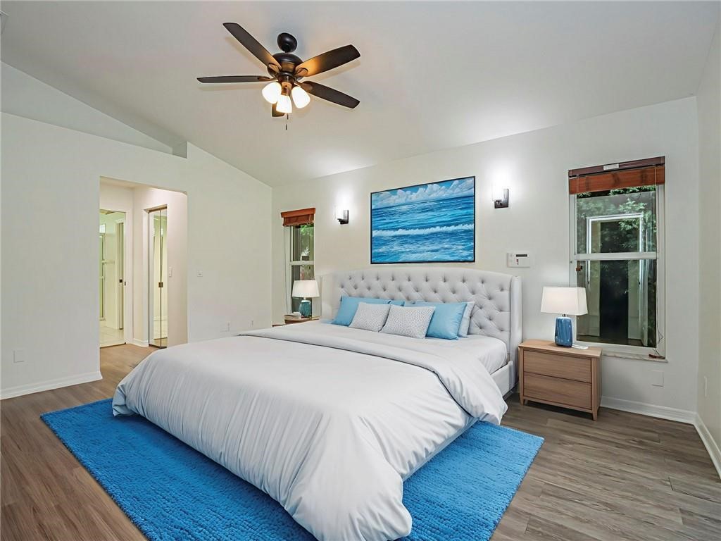 6445 55th Square Vero Beach, FL 32967 - Photo 12 of 36 a bedroom with a bed and a ceiling fan