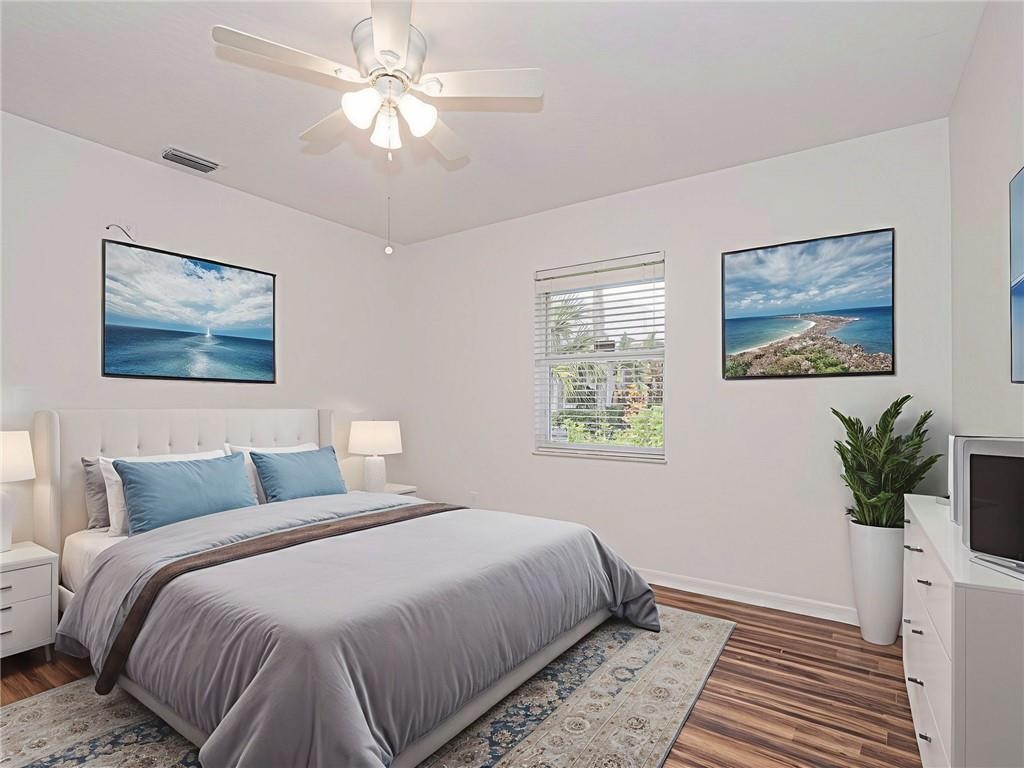 6445 55th Square Vero Beach, FL 32967 - Photo 15 of 36 a bedroom with a large bed and a window