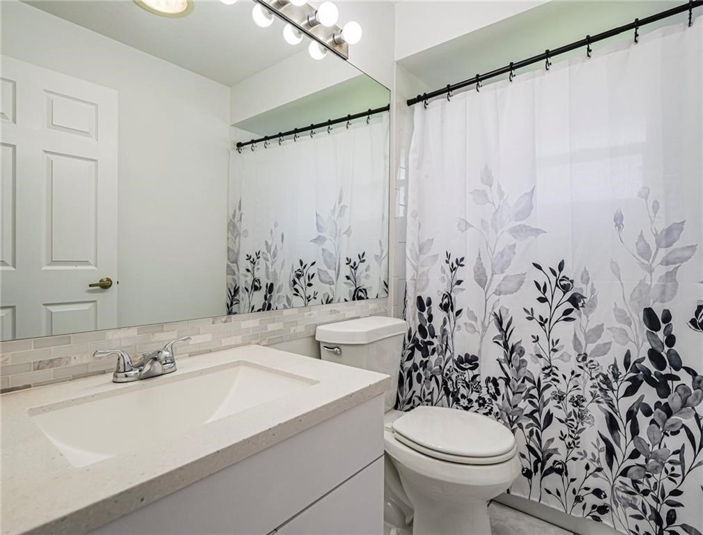 6445 55th Square Vero Beach, FL 32967 - Photo 17 of 36 a bathroom with a sink and a toilet