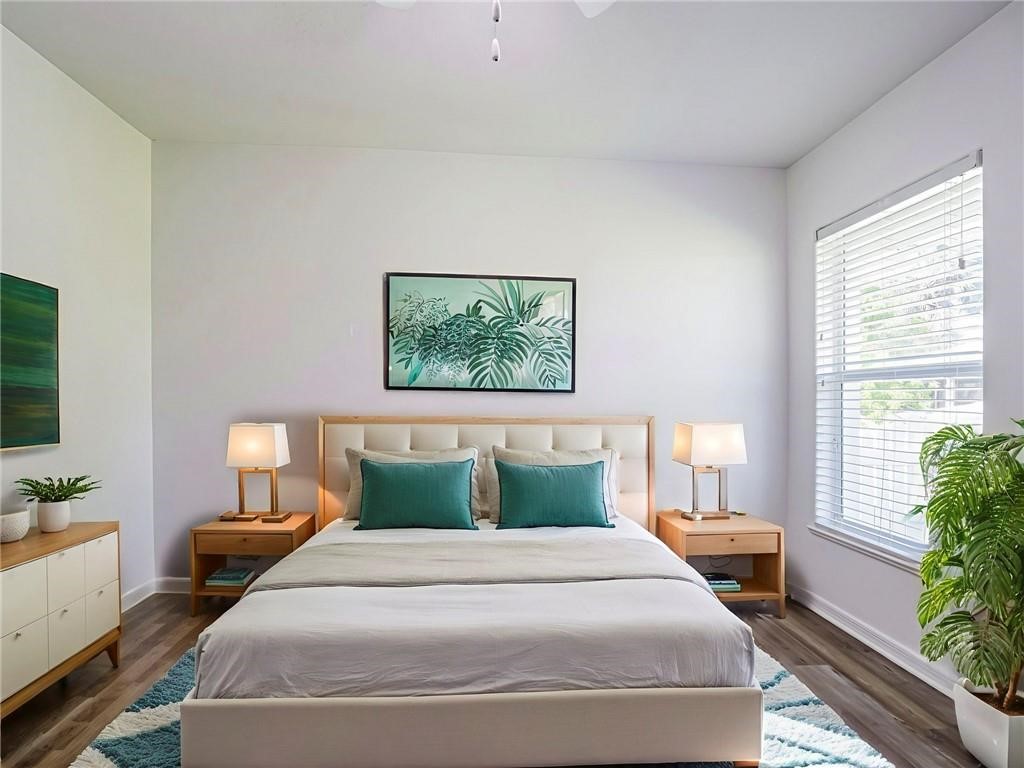 6445 55th Square Vero Beach, FL 32967 - Photo 18 of 36 a bedroom with a bed and a potted plant