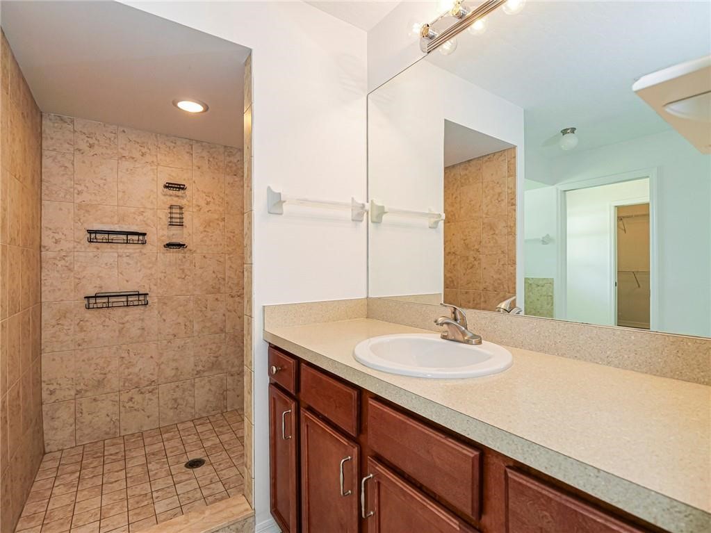 6445 55th Square Vero Beach, FL 32967 - Photo 23 of 36 a bathroom with a sink shower and a mirror