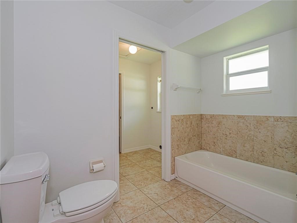 6445 55th Square Vero Beach, FL 32967 - Photo 25 of 36 a bathroom with a toilet and bathtub
