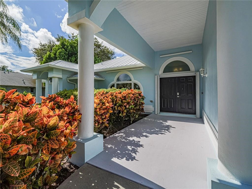 6445 55th Square Vero Beach, FL 32967 - Photo 3 of 36 front view of a house with a porch