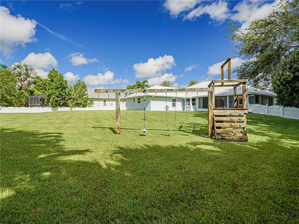 6445 55th Square Vero Beach, FL 32967 - Photo 33 of 36 a front view of a house with a yard