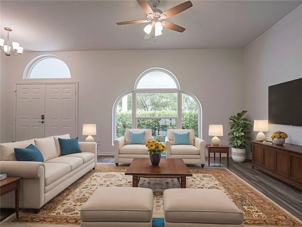 6445 55th Square Vero Beach, FL 32967 - Photo 6 of 36 a living room with furniture and a large window