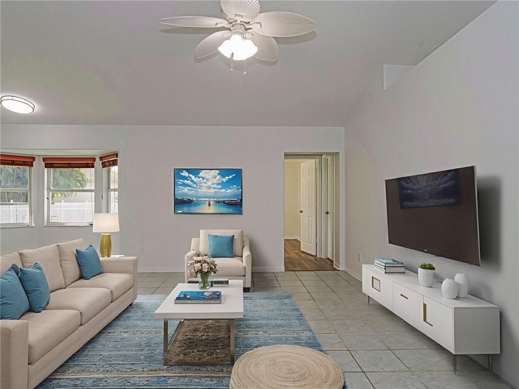 6445 55th Square Vero Beach, FL 32967 - Photo 10 of 36 a living room with furniture and a flat screen tv