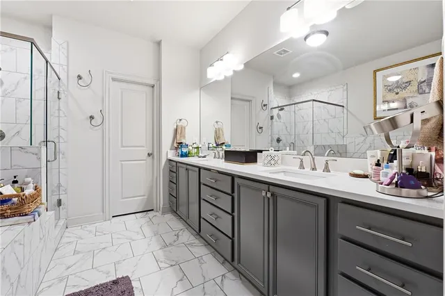 a bathroom with a sink double vanity and shower