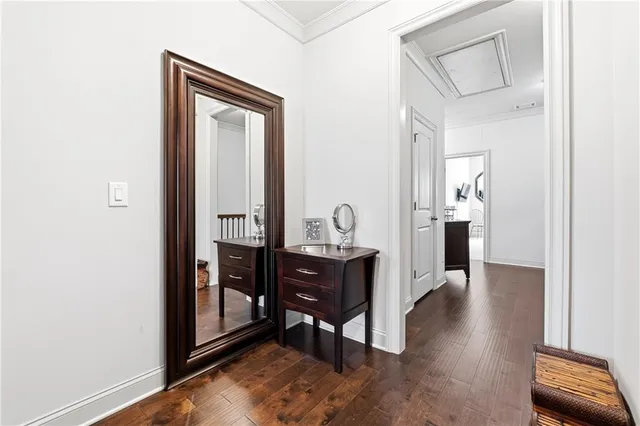 a view of a hallway to a livingroom and a dining room with furniture
