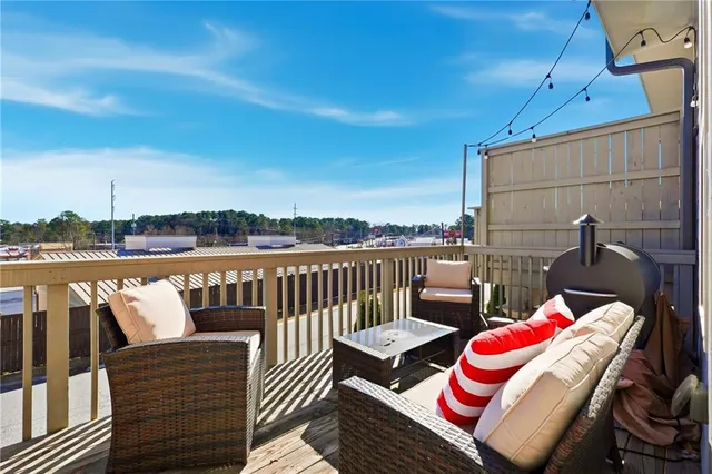 a balcony with an outdoor seating