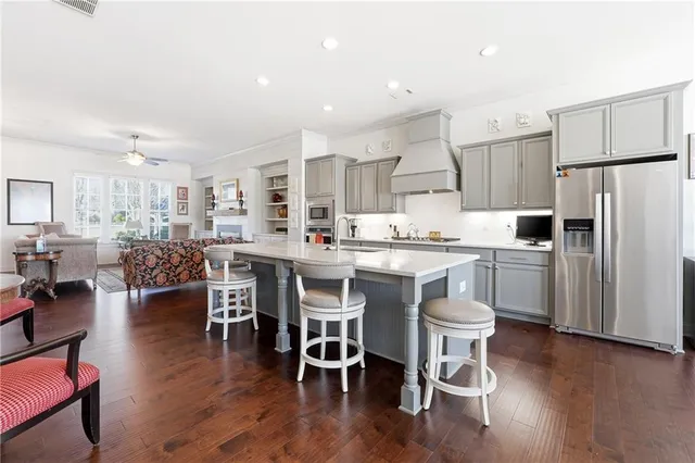 a kitchen with a dining table chairs refrigerator and cabinets