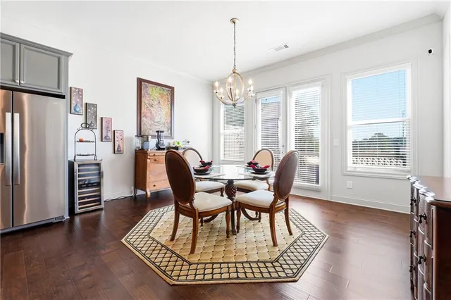 a dining room with furniture a chandelier and wooden floor