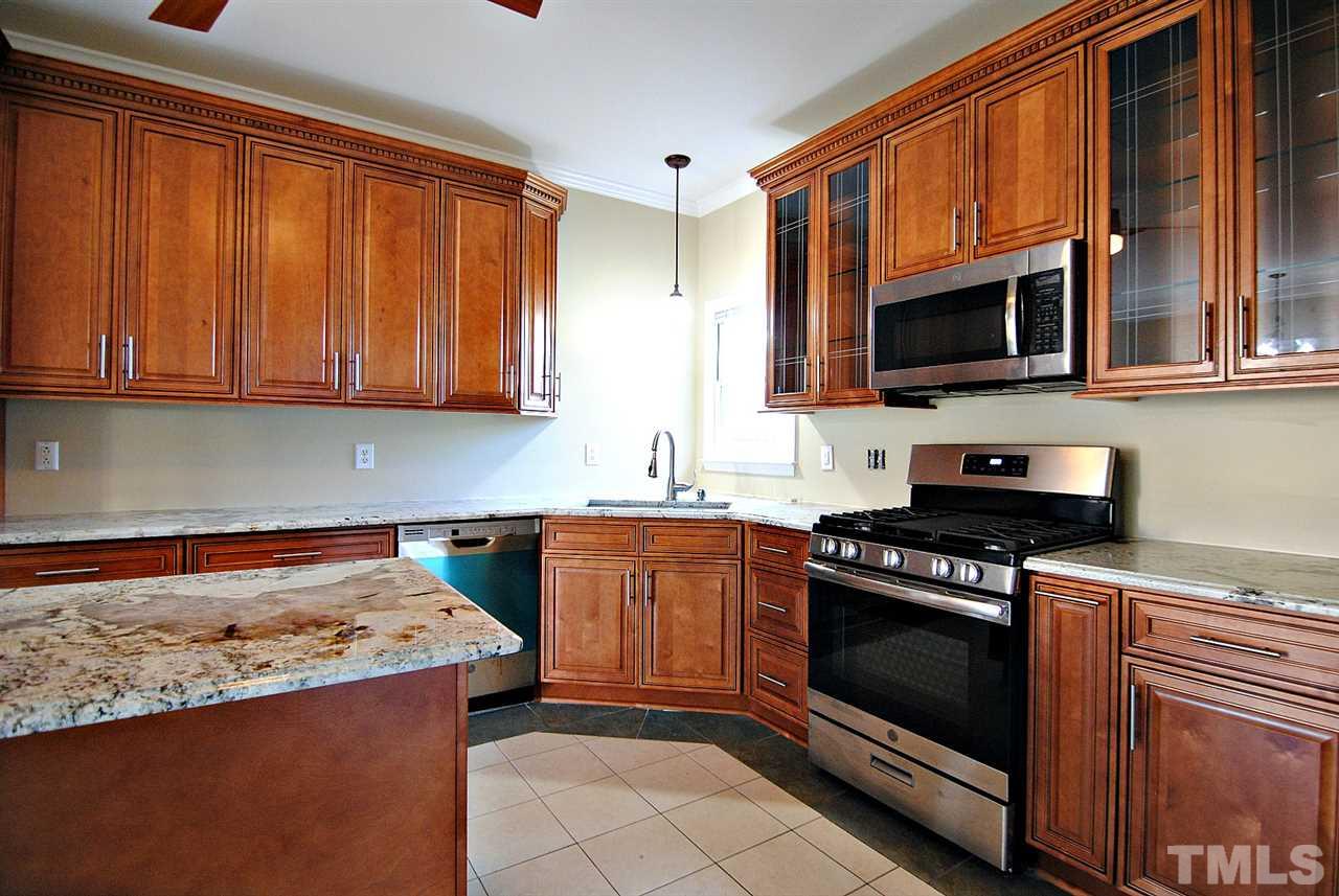 2216 Dahlgreen Road Raleigh, NC 27615 - Photo 11 of 22 a kitchen with stainless steel appliances granite countertop a stove top oven microwave and cabinets