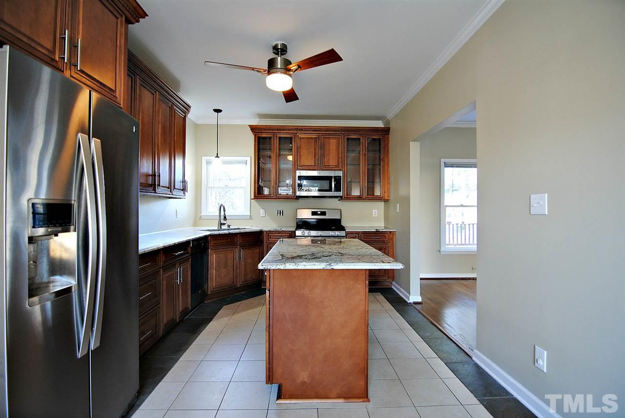 2216 Dahlgreen Road Raleigh, NC 27615 - Photo 12 of 22 a kitchen with stainless steel appliances granite countertop a stove a refrigerator and a sink