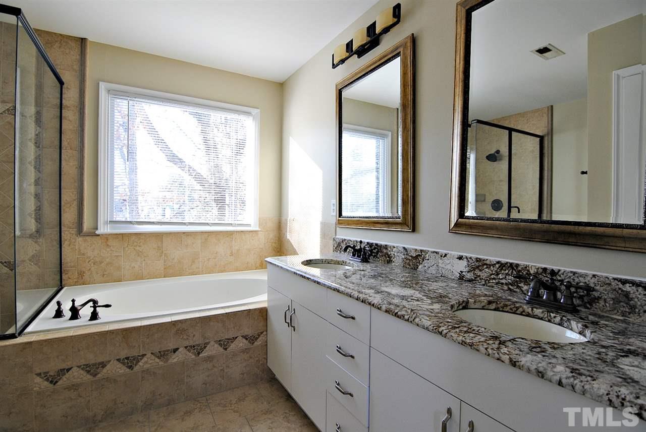 2216 Dahlgreen Road Raleigh, NC 27615 - Photo 16 of 22 a bathroom with a granite countertop tub and a sink