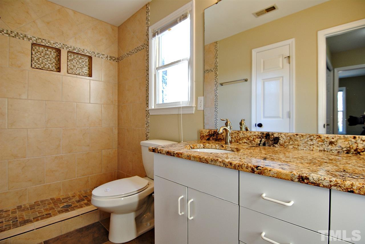 2216 Dahlgreen Road Raleigh, NC 27615 - Photo 19 of 22 a bathroom with a granite countertop sink a toilet and a mirror