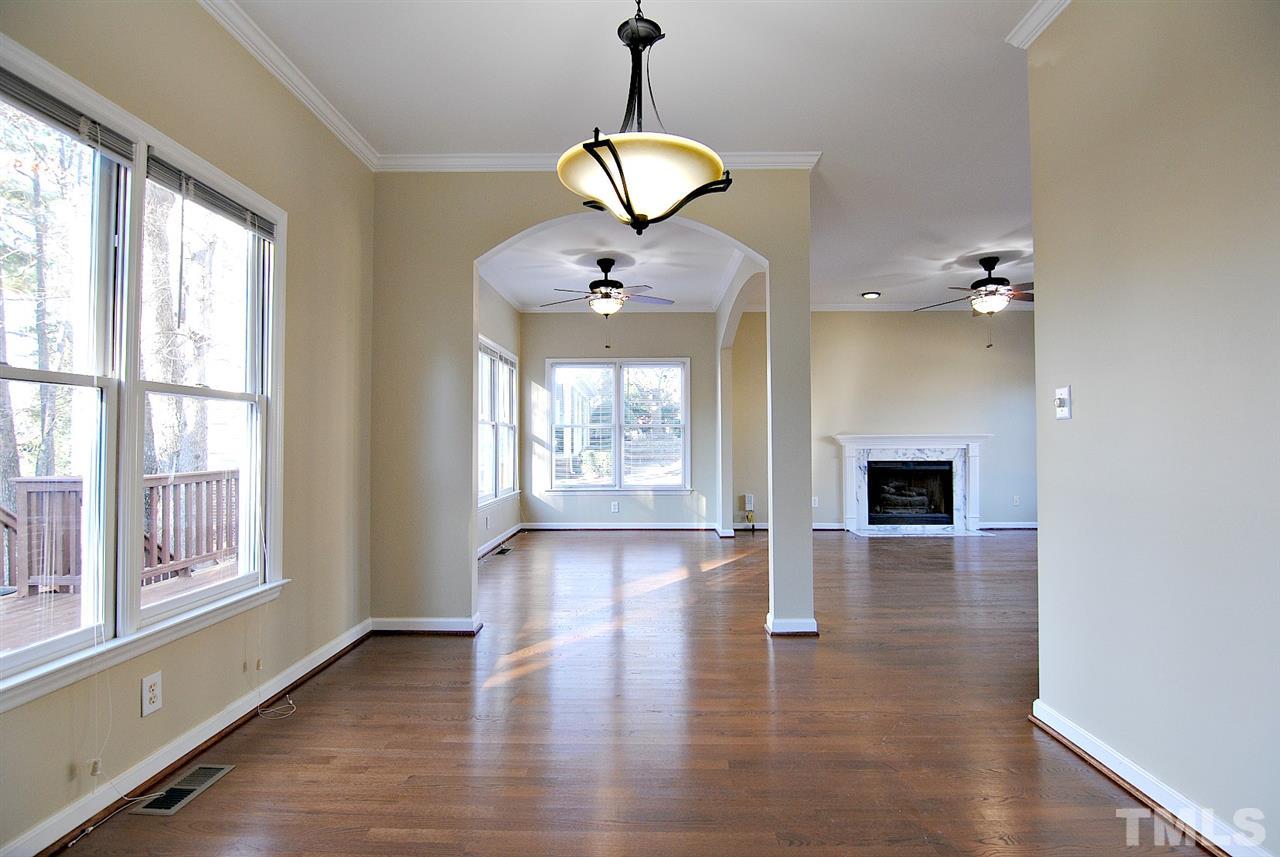 2216 Dahlgreen Road Raleigh, NC 27615 - Photo 7 of 22 a view of an empty room with wooden floor and a window