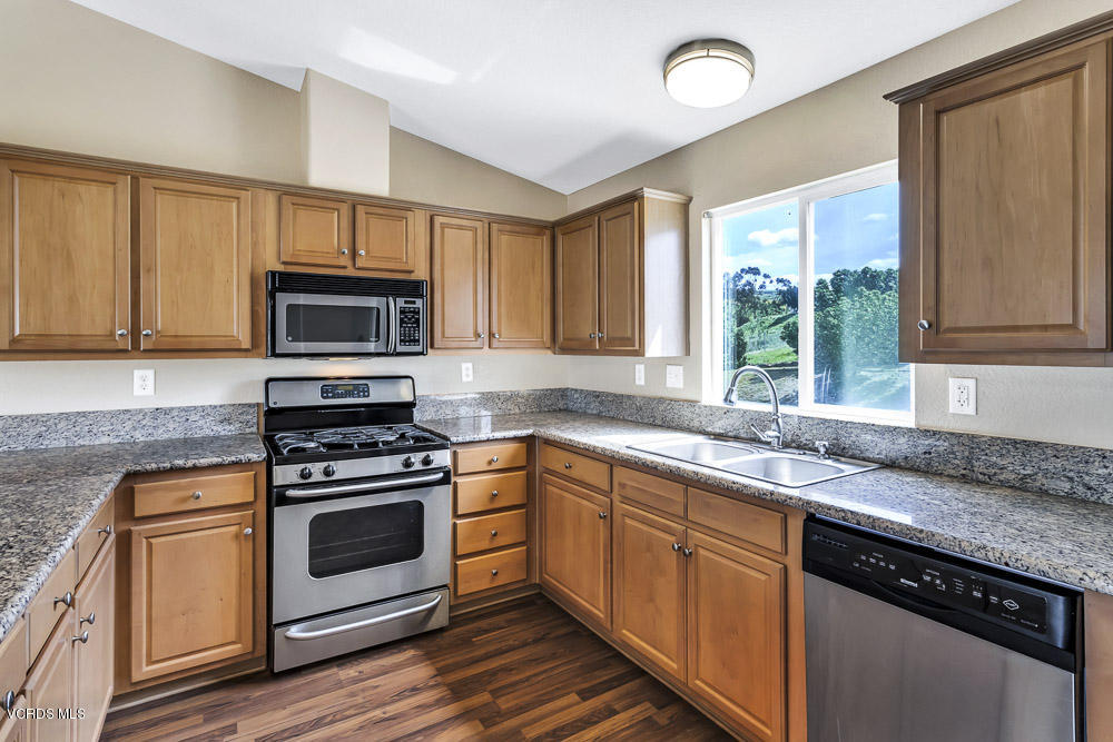 15535 LaPeyre Road Moorpark, CA 93021 - Photo 14 of 34 a kitchen with granite countertop a sink cabinets stainless steel appliances and a window