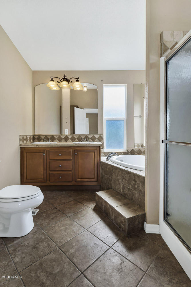 15535 LaPeyre Road Moorpark, CA 93021 - Photo 23 of 34 a bathroom with a toilet a sink and mirror