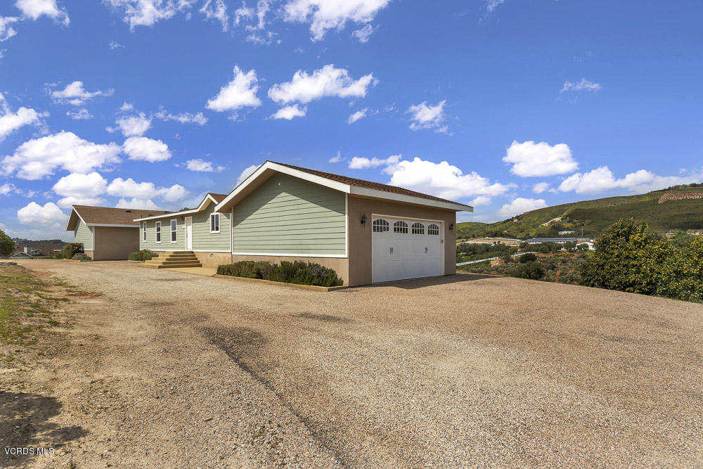 15535 LaPeyre Road Moorpark, CA 93021 - Photo 5 of 34 a front view of a house with a yard and garage