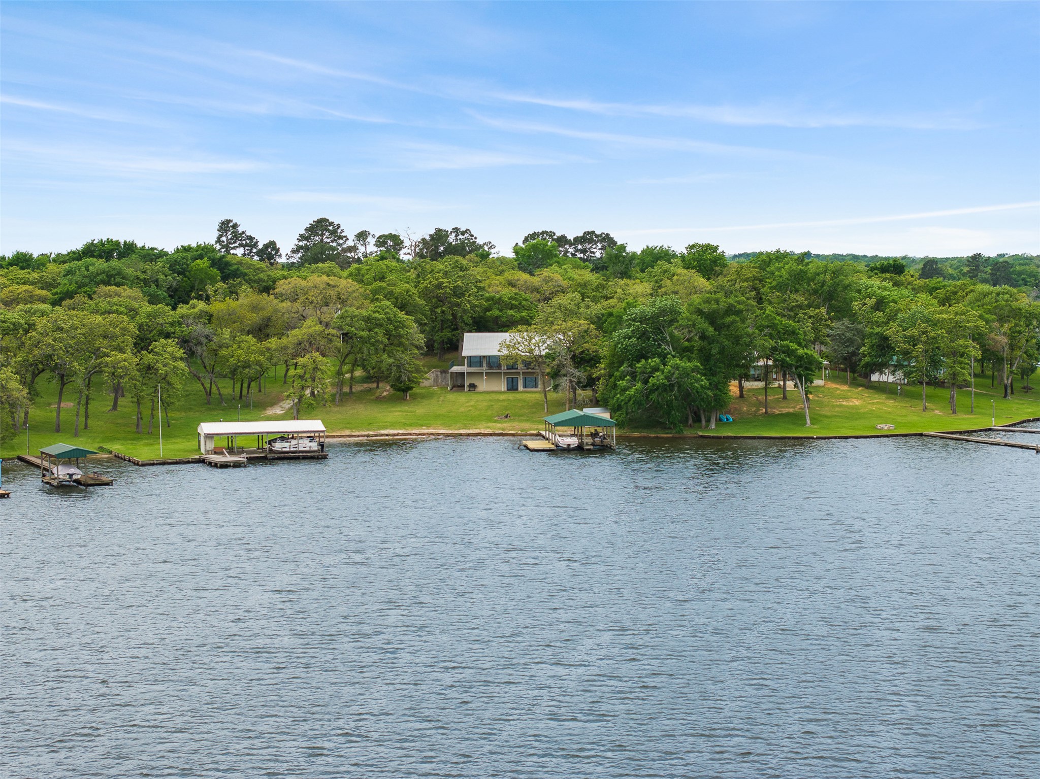 10959 Clyde Acord Road Franklin, TX 77856 - Photo 37 of 39 a view of a lake with houses in the back