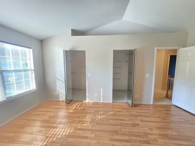 a view of a livingroom with wooden floor and a window