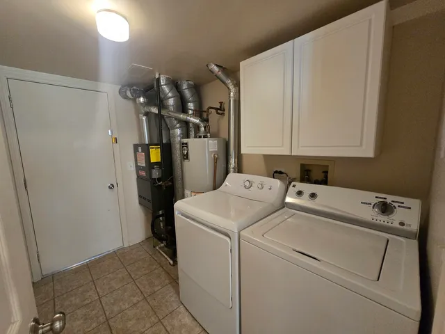a view of storage and utility room with washer and dryer