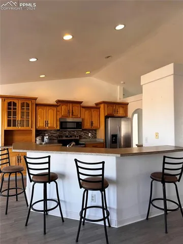 a kitchen with a table chairs and a refrigerator