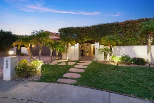 a view of a garden with a building in the background