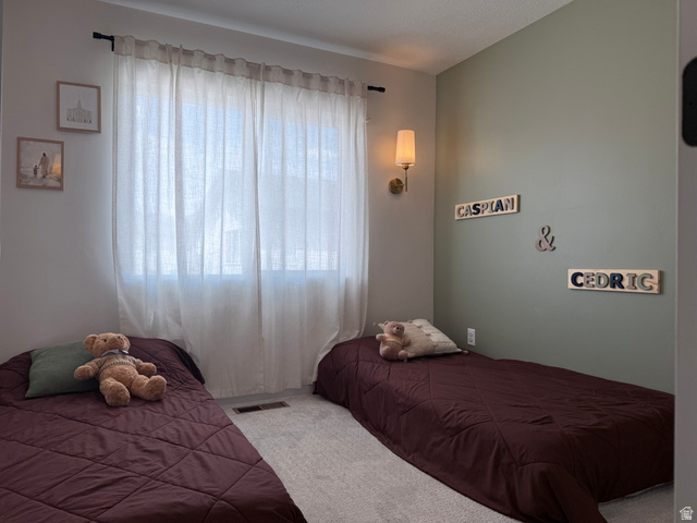 774 West 480 South American Fork, UT 84003 - Photo 68 of 76 Bedroom featuring light gray wall paint, an accent wall with sage green paint, and light-colored carpet flooring