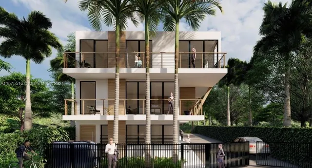 a front view of residential houses with yard and green space