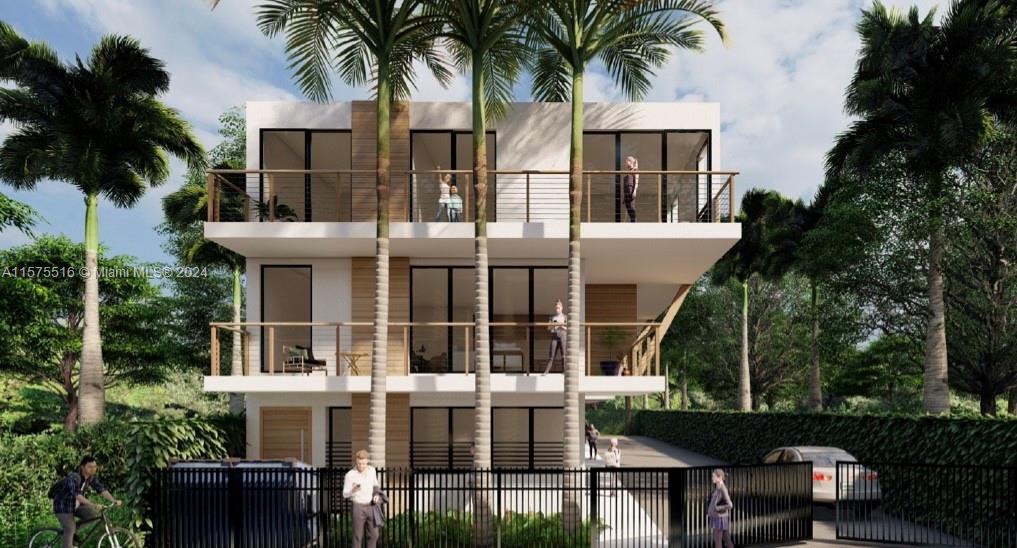 737 Northwest 30th Street Miami, FL 33127 - Photo 3 of 5 a front view of residential houses with yard and green space