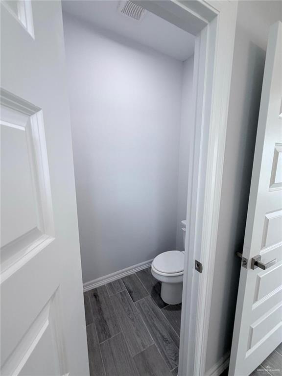 1724 Clinton Street Harlingen, TX 78550 - Photo 13 of 23 a bathroom with a toilet and a sink