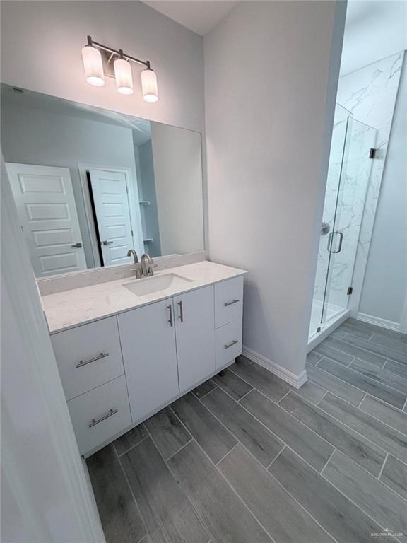 1724 Clinton Street Harlingen, TX 78550 - Photo 14 of 23 a spacious bathroom with a double vanity sink and a mirror