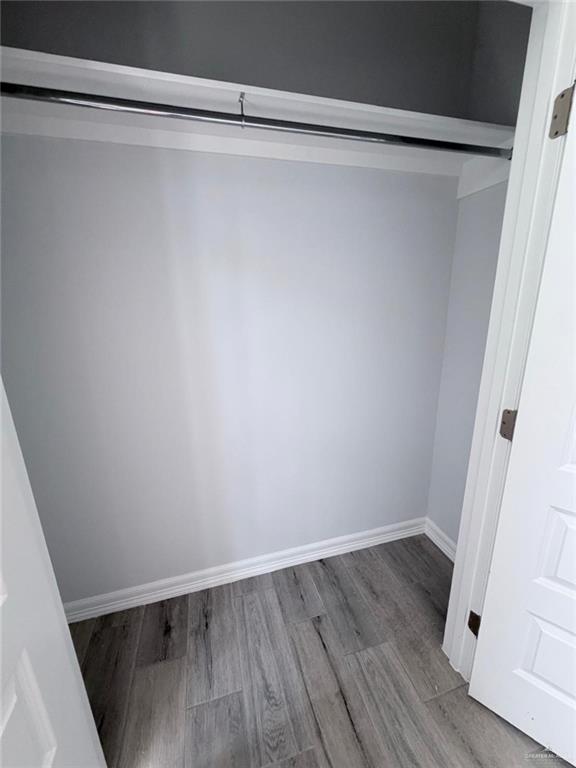 1724 Clinton Street Harlingen, TX 78550 - Photo 8 of 23 a view of a room with wooden floor and white walls