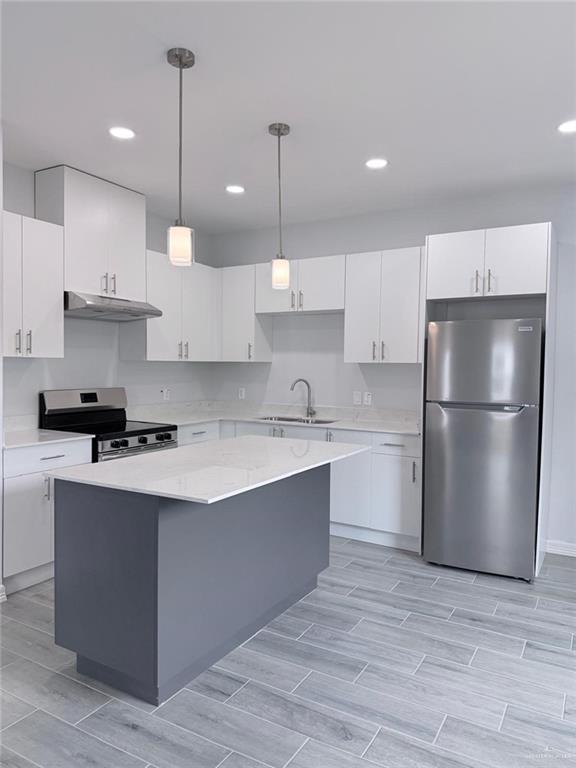 1724 Clinton Street Harlingen, TX 78550 - Photo 9 of 23 a kitchen with kitchen island a sink stainless steel appliances and cabinets
